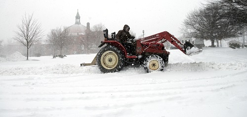 Winter Storm Jonas: Vlad Iurco drives a tractor to clear snow form a parking lot of One Oak Plaza in downtown Asheville, North Carolina 22 Jan 2016 (ddp USA/REX Shutterstock) 