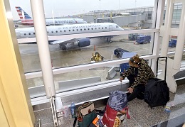 Winter Storm Jonas hits America - 22 Jan 2016 A passenger rests on the floor while waiting for her flight at the Ronald Reagan National Airport in Washington D.C (Xinhua News Agency/REX Shutterstock)