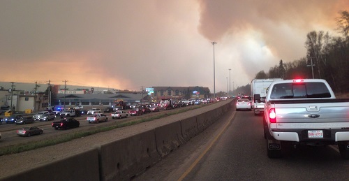 Residents flee the area around Fort McMurray, Alberta, on 4 May as a wildfire spreads. (Canadian Press/REX/Shutterstock)
