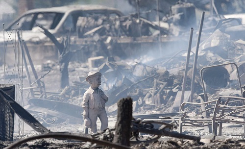 Homes are left in smouldering ash in Slave Lake, Alberta, on 4 May amid the wildfire. (Canadian Press/REX/Shutterstock) 