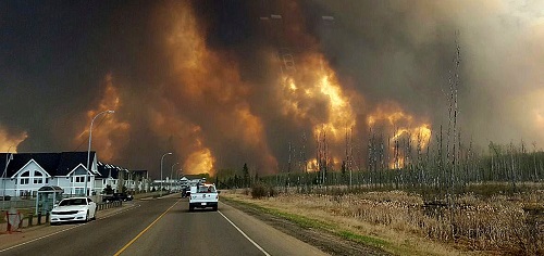 Authorities evacuated thousands from the area around Fort McMurray, Alberta, by 9 May as firefighters gradually go the upper hand on a massive wildfire. (Canadian Press/REX/Shutterstock)