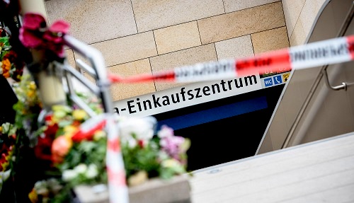 Residents leave flowers at the subway entrance near the scene of Friday’s mass shooting in Munich on Saturday, 23 July 2016. (Action Press/REX/Shutterstock)