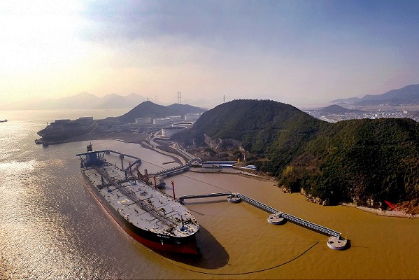 Crude oil is being unloaded from an oil tanker on a quay in Zhoushan city, east China