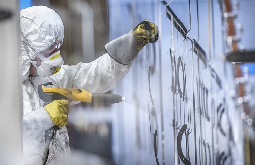In a market that has historically reflected oversupply and thin margins even during peak demand from its principal downstream paint and coatings sector, the tide may begin to turn this year. Above, a factory worker spray paints coating. (Cultura/REX/Shutterstock)