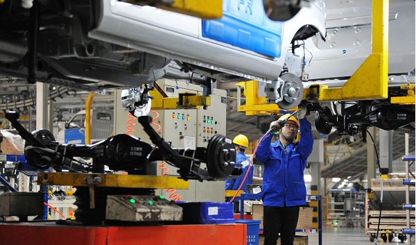 Picture: A Chinese worker assembles cars on the assembly line at an auto plant (Imaginechina/REX/Shutterstock) 