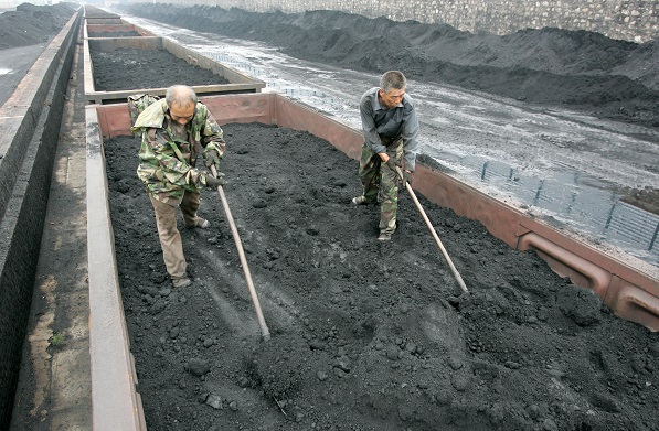 Workers load a coal truck at a coal dump in Taiyuan, Shanxi Province, China Photographer: VIEW CHINA PHOTO/REX/Shutterstock