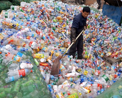 A man searches a landfill for useful and recylable plastics in China (Source:Imaginechina/REX/Shutterstock)